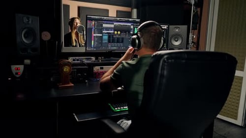 On the sound engineer's computer monitor sound tracks for mixing a new soundtrack that girl sings