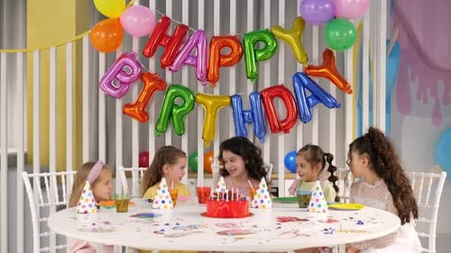 Girls Celebrate Birthday at Festive Party Table