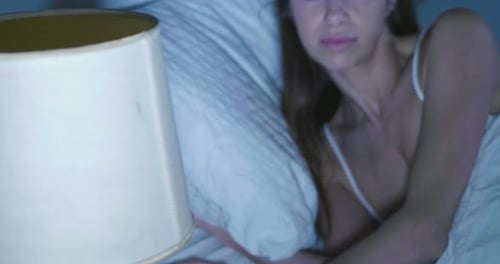 Woman Sleeping Peacefully in Bed at Night