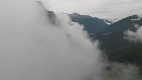 Aerial view of mountain peaks and valley, Italy.