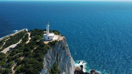 Seaside Lighthouse on a Sunny Day with Blue Ocean Backdrop