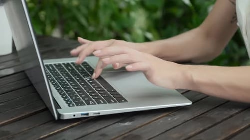 Typing on Laptop Keyboard Outside