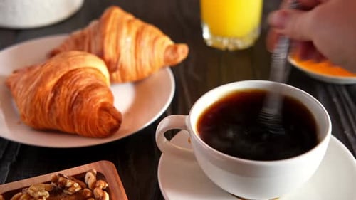 Delicious Breakfast with Coffee, Croissants, and Juice