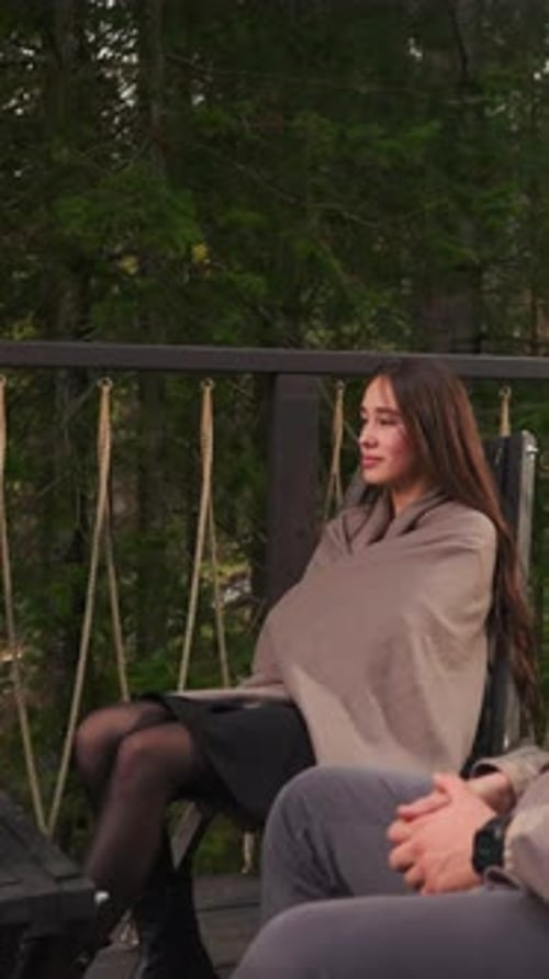 Gentleman and Lady Relax on Terrace at Dusk