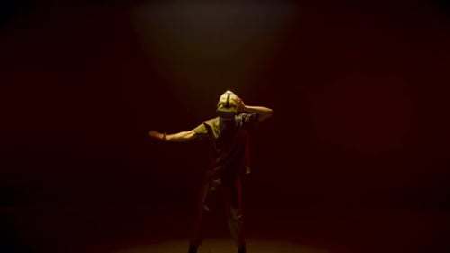 Man Wearing VR Headset Dancing Under Colorful Lights