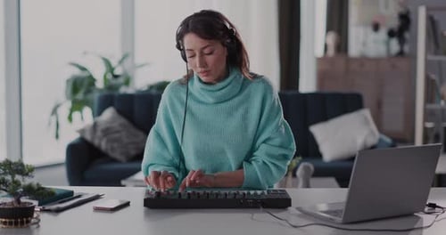 Woman Composes Music on Keyboard in Home Studio
