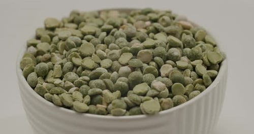 White Bowl of Dried Green Split Peas Rotating