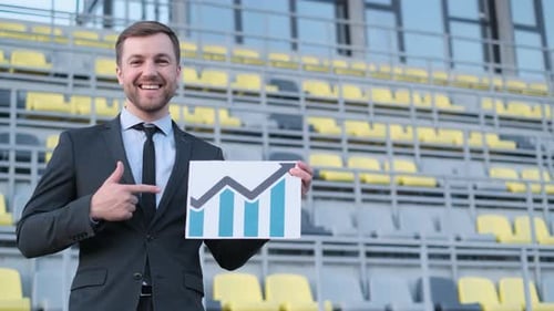 A Young Business Worker Shows a Career Growth Chart Finance Concept