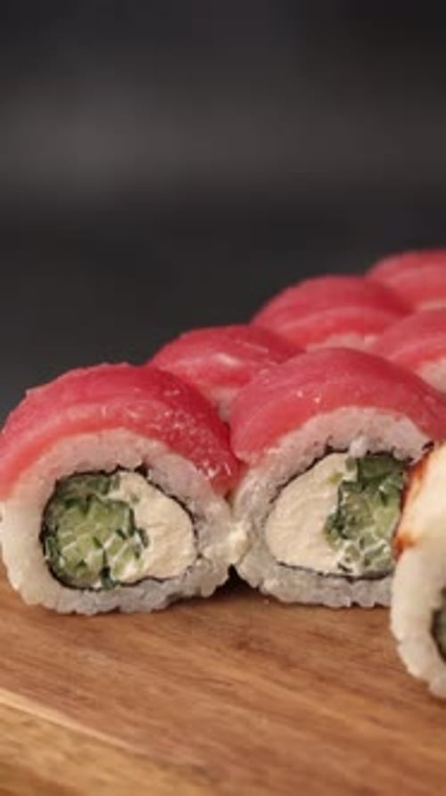 Close Up of Sushi Rolls on Wooden Board