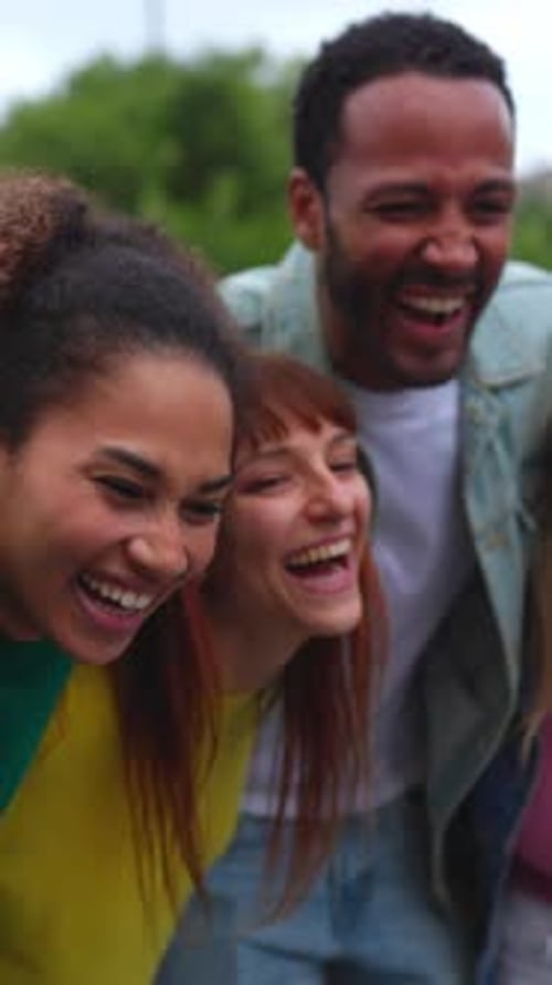 United Group of College People Having Fun Laughing Together Outdoors