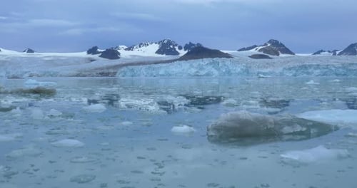 Sailing in Ice water near iceberg and mountains
