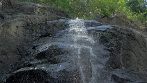 Closeup Slow Motion Shot of Small Waterfall in the Tropical Rainforest Jungle of Philippines Small