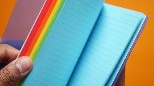 Rainbow Notebook Pages Being Flipped Open Close Up