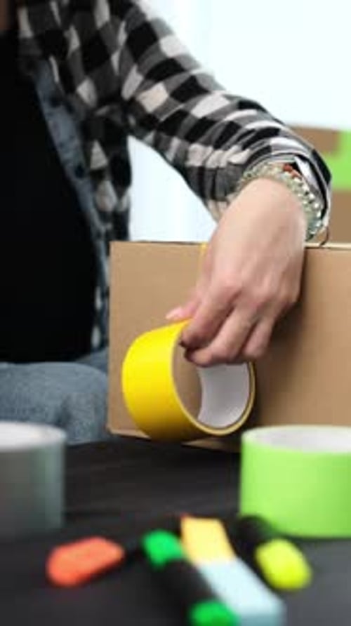 Girl Packing Packing A Cardboard Box For Shipping