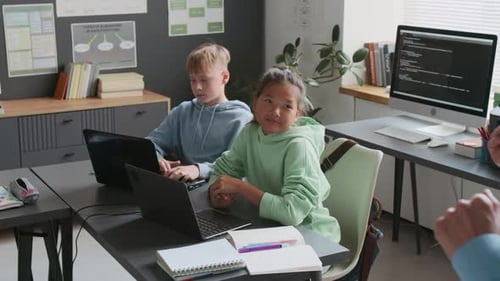 Children Learning Code in Classroom with Instructor