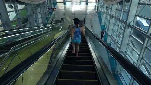 Woman Jogging on Escalator Stairs in City Super 240