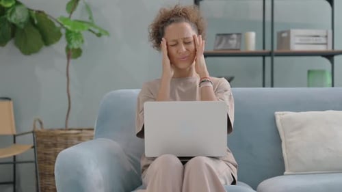 Woman Working on Laptop Experiences Headache