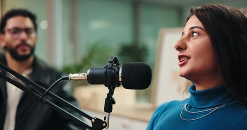 Woman, man and laugh for podcast with microphone, interview and questions for studio guest