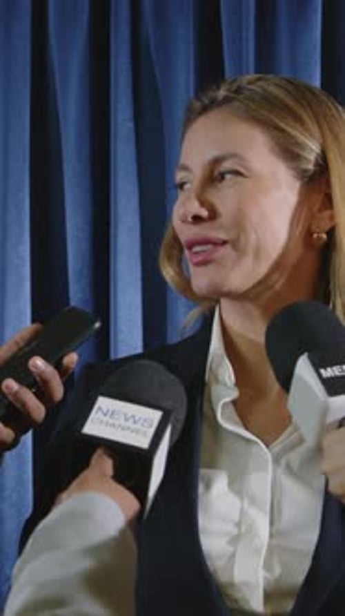 Confident Woman Giving an Interview to Reporters