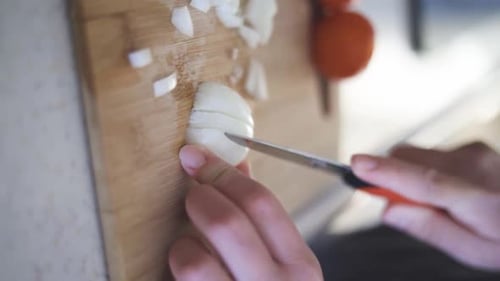 Dicing an onion on a Wooden Cutting Board
