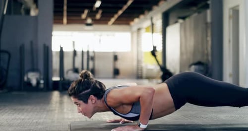 4k video footage of an attractive young sportswoman doing push ups at the gym