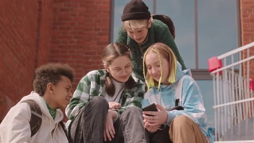 Teen Friends Looking at a Phone Together