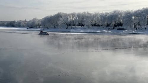 A rescue hovercraft navigates a frozen river