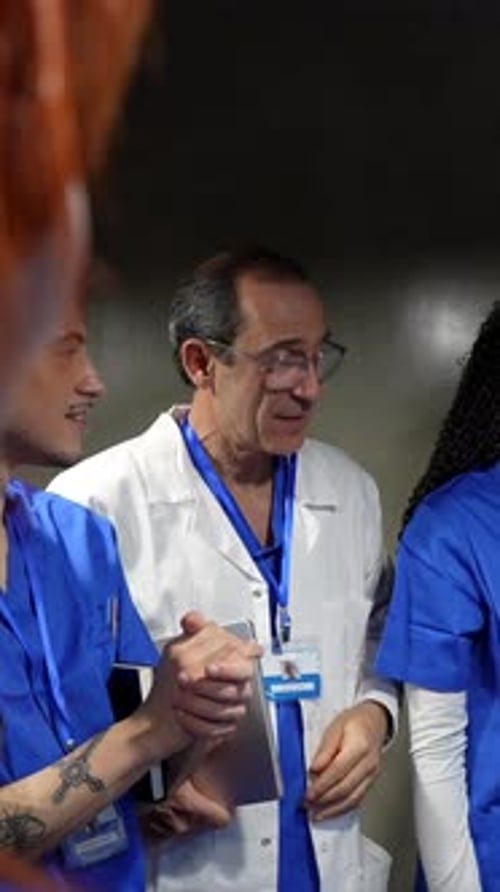 Medical staff discussing patient case in hospital corridor