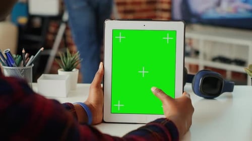 Person Holding Tablet with Green Screen Display
