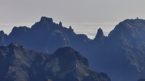 High Altitude Rugged Mountains at Dawn with Distant Ocean View