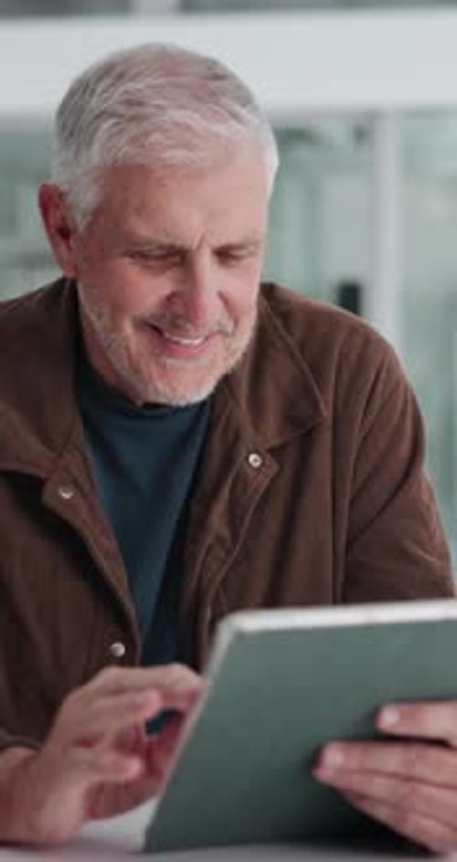 Mature man, tablet and happy at startup, scroll and review with project management at media company