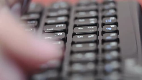Person Typing on a Computer Keyboard Close Up