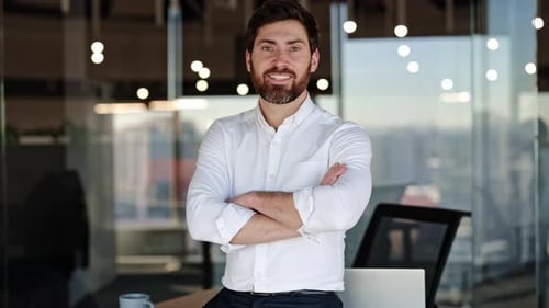 Confident Businessman Smiling in Modern Office Setting Embracing Success and Leadership