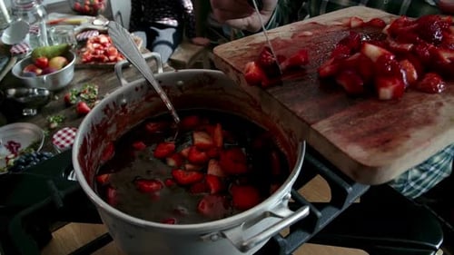 Chopped Strawberries Falling into Boiling Pot for Jam
