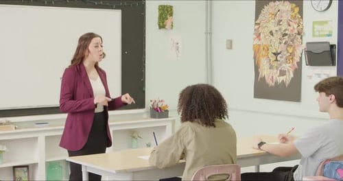 Students Learning in School Class Room. High School or College Class Raising Hand Asking Questions