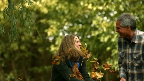 Happy Couple Plays Together Throwing Autumn Leaves
