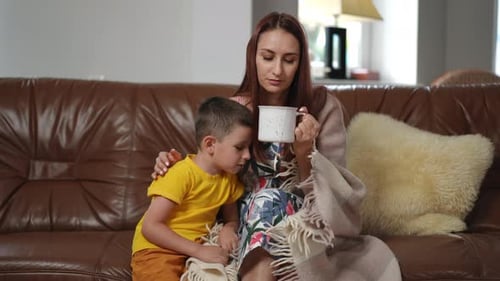 Mother and Child Relaxing Together on Sofa