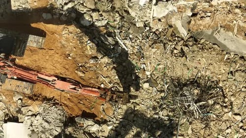 Excavator arm demolishing an old building, Aerial view