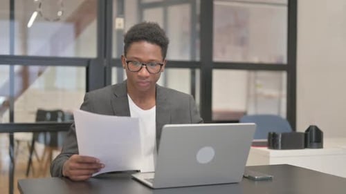 Young Adult Celebrates Business Success in Modern Office