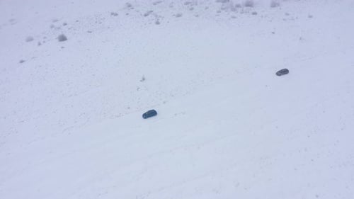 Aerial View of a Cars Driving on a Winter Road in Misty, Foggy Winter Weather