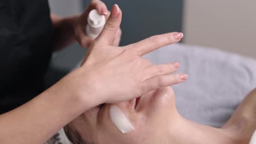 Woman Receives Facial Treatment in Clinic