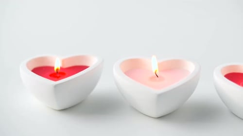 St Valentines Day and Decoration Concept - Heart Shaped Candles Burning Alight