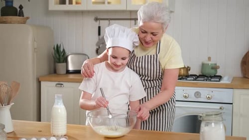 Child and Adult Baking Together in Kitchen