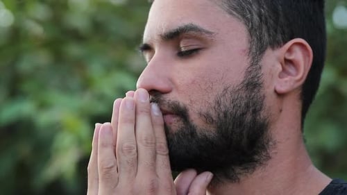 Homme hispanique spirituel se sentant libre, respirant profondément à l'extérieur