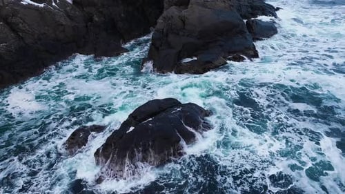 Waters of the Ocean Swirl Around the Rocky and Scenic Coastline Sea Waves Breaking Over Rocks