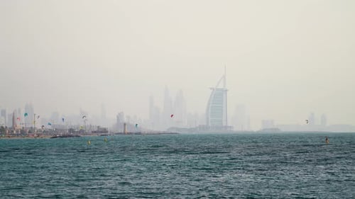 Kite surfing for leisure at kite beach Dubai against the famous landmark background