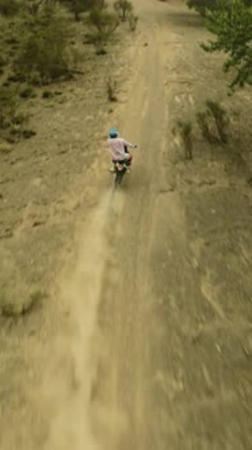 Motorcyclist Climbs on Dusty Hill Fpv