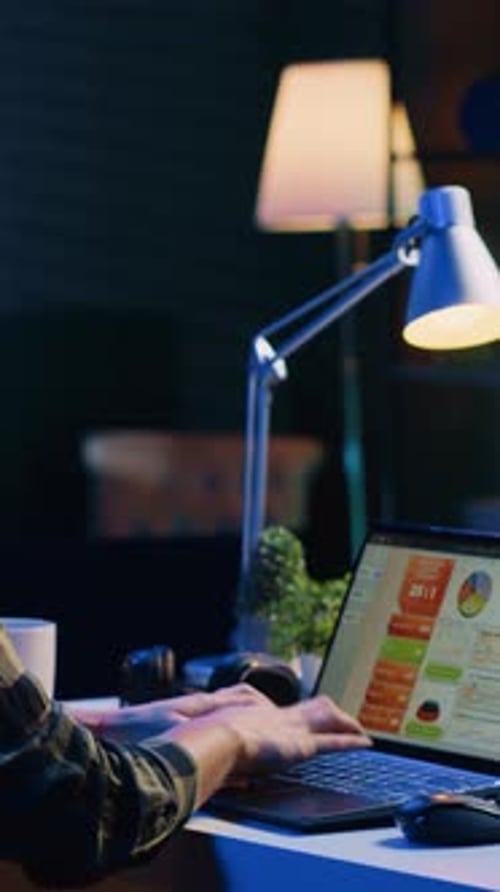 Vertical Video Man Working in Personal Office Checking Statistical Data Financial Graphs