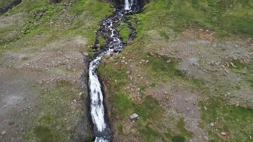 Aerial view of a waterfall in East Fjords region of Iceland.