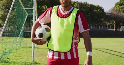 Video of biracial male football players with ball on field